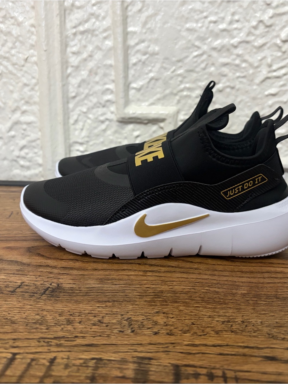 Nike Kids Black and Gold Slip-On Athletic Sneakers